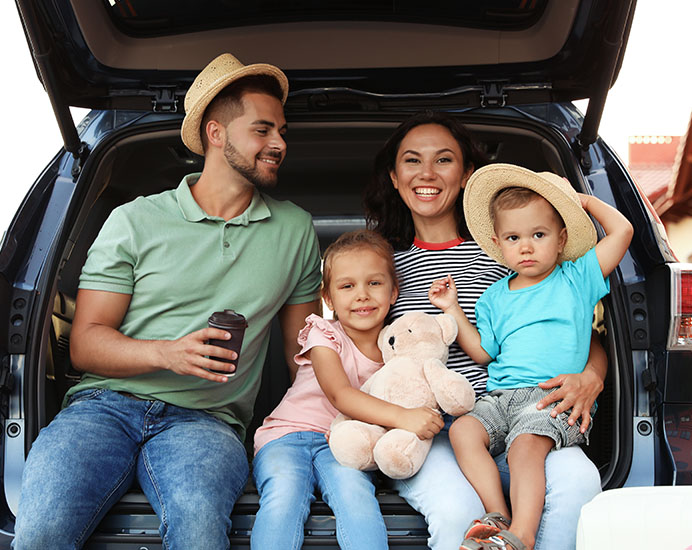 Family sitting in a refinanced car